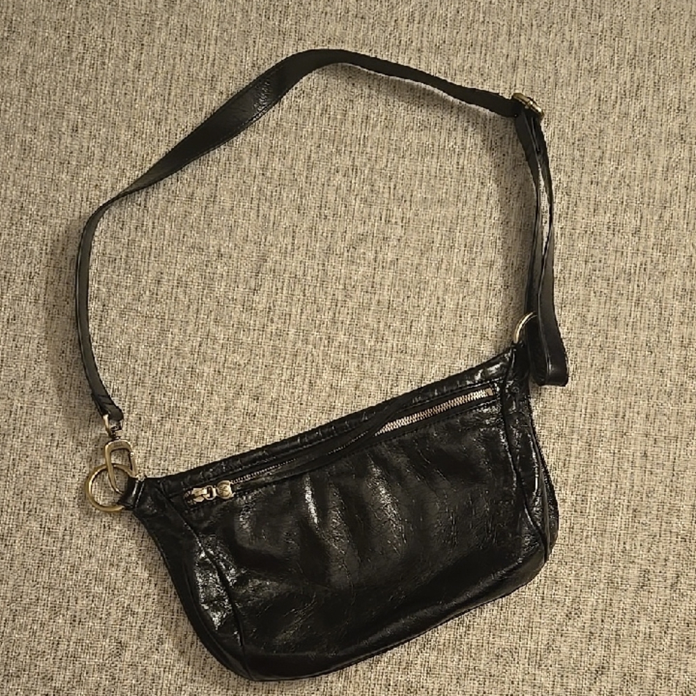 Hobo Flywheel Sling Bag In Polished Black Leather